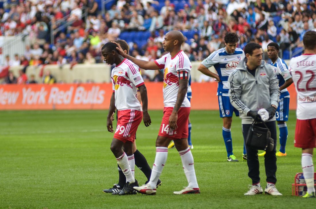 Henry consoles injured teammate Bradley Wright-Phillips.